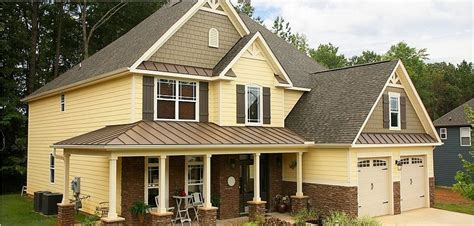 interactive yellow houses with metal brown roof|yellow brick house ideas.